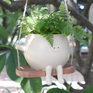 A decorative flower pot designed to hang or swing, adding charm to any garden or space.