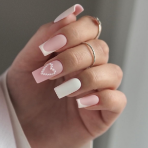 Heartfelt nail featuring a mixture of white and baby pink nail with white pearl that designs a heart