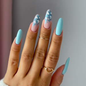 Close-up of beautifully designed Valentine’s Day nails featuring baby blue nail color and two blue french tips with white hearts