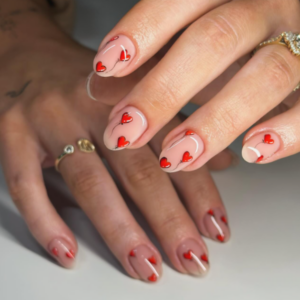 Close-up of beautifully designed Valentine’s Day nails featuring red heart balloon