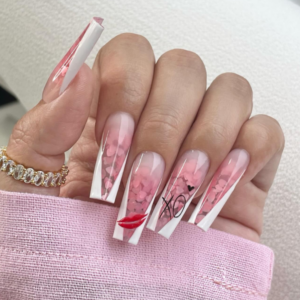 Close-up of beautifully designed Valentine’s Day nails featuring white french tips with pink glitter, kiss and XO design