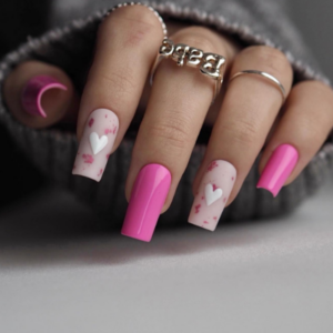 Close-up of beautifully designed Valentine’s Day nails featuring pink nails with white and pink hearts design