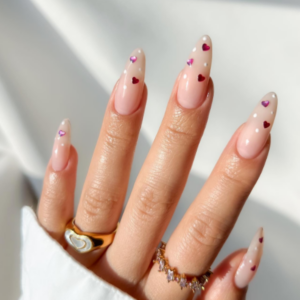 Close-up of beautifully designed Valentine’s Day nails featuring red heart diamond