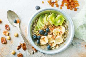 A delicious and simple breakfast of a smoothie bowl and fresh fruit, ideal for a stress-free morning.