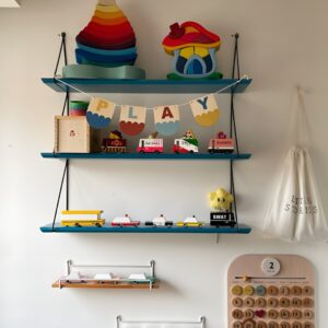 Bookshelves featuring cubbies with fabric bins for toy storage, alongside open spaces for displaying larger toys.