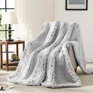 Cozy chunky knit throw blanket, ideal for book lovers who love to snuggle up and read.