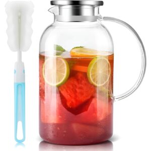 A heat-resistant glass pitcher filled with iced tea on a kitchen counter.