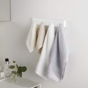 Adhesive hooks used to hang bathroom tools like brushes and razors for easy access.