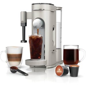 A sleek coffee maker brewing a fresh cup of coffee, with coffee beans and a mug nearby. Great Housewarming gift