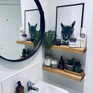 Floating shelves installed on the bathroom wall for extra storage without taking up floor space.