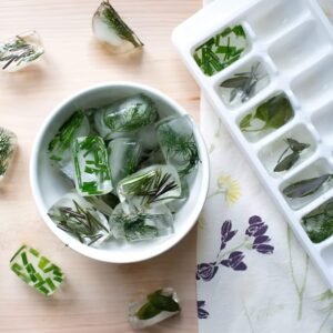 Fresh herbs stored in jars with water in the fridge to prolong their lifespan.