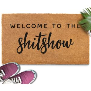 A humorous doormat with a cheeky welcome message at a front door. Funny Housewarming gift