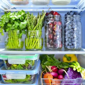 Fresh herbs stored in jars with water to prolong their lifespan.