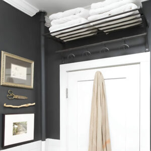 A hidden storage shelf above the door for keeping extra bathroom supplies.