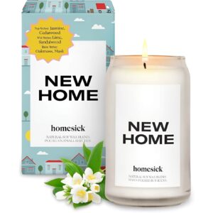 A Memory Homesick New Home Candle glowing warmly in a cozy setting.