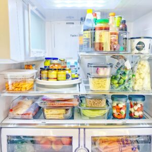 A Lazy Susan in the fridge holding condiments for easy access and rotation.