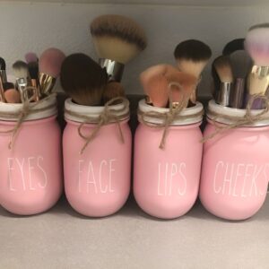 DIY mason jar storage for organizing makeup brushes on a vanity or countertop.