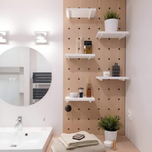 A pegboard mounted on the bathroom wall for customizable storage of toiletries and accessories.