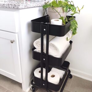 A compact rolling cart with multiple shelves for flexible bathroom storage.