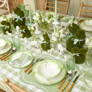 A fresh, nature-inspired Easter table with a green runner, wooden accents, wildflowers, and small bird nests with decorative eggs.